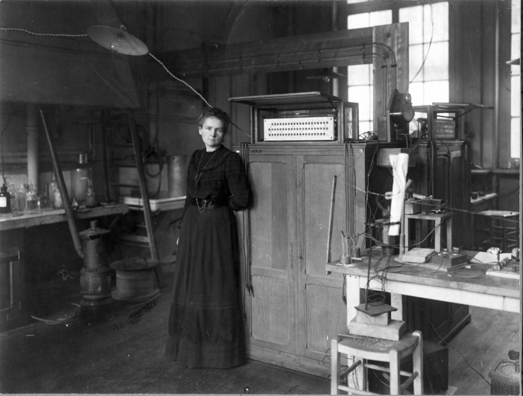 black and white photograph portrait of Madame Curie in her lab