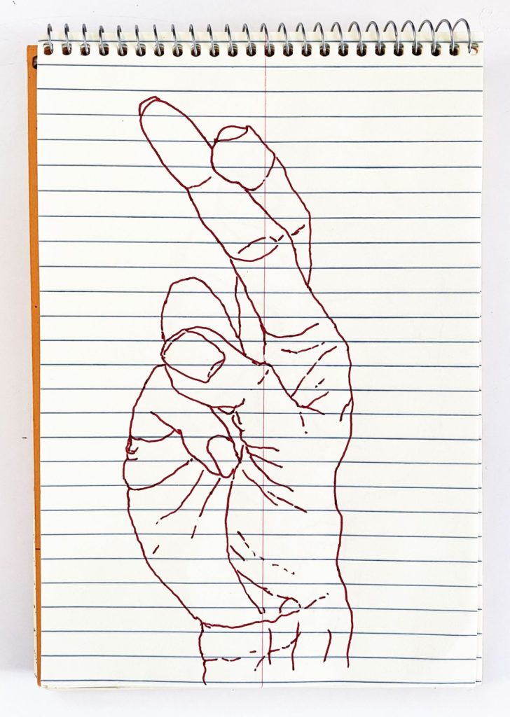 An outline handsketch of a hand shaping the ASL American manual letter “R”, in red ink on a yellow spiral bound steno notebook. 