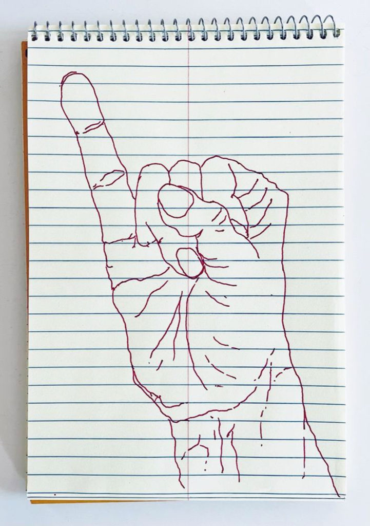 An outline handsketch of a hand shaping the ASL American manual letter “I”, in red ink on a yellow spiral bound steno notebook. 